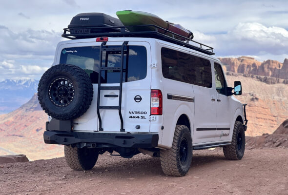 Nissan NV3500 outfitted with Avatar Offroad accessories in Moab UT - slick side step running boards, rear ladder, rear bumper, spare tire holder, safari roof rack, and pioneer front bumper with winch